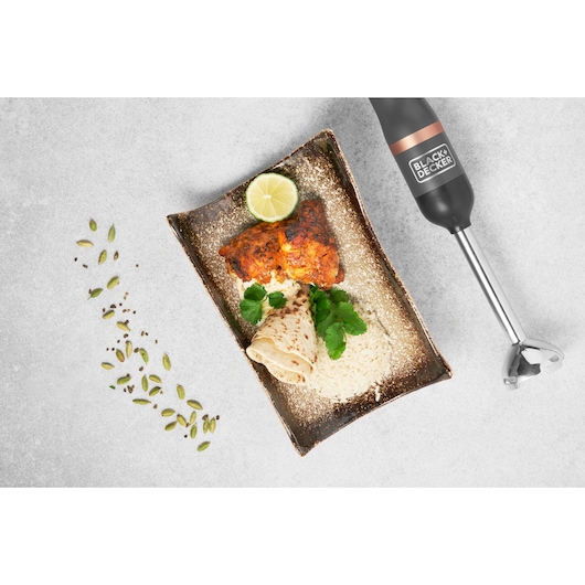 BLACK+DECKER BCKM1011KGF hand blender flat lay with plate of grilled chicken, rice, flatbread, herbs, and lime.