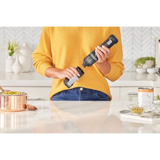 Photo of BLACKDECKER BCKM1012KB cordless handheld mixer in use in a modern kitchen setting.