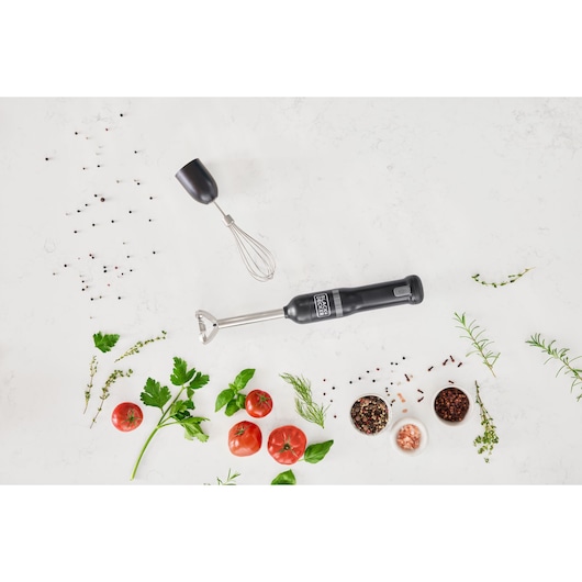BLACK+DECKER hand blender with whisk attachment BCKM1012KB, top view on white background with herbs and tomatoes.