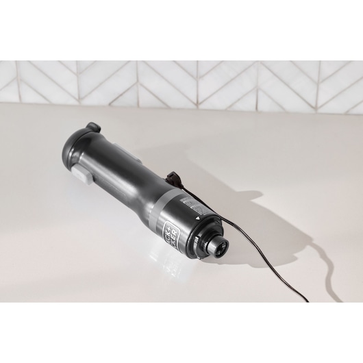 Photo of BLACK+DECKER handheld rotary tool BCKM1012KB, black and silver, angled view on white surface.