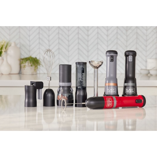 Photo of BLACK+DECKER BCKM1016KSB hand blender set with multiple black and red attachments on a kitchen counter.