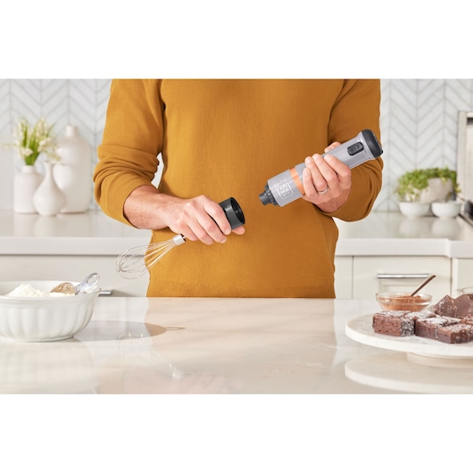 Photo of BLACKDECKER BCKM1016KSG hand mixer attachment being assembled in a modern kitchen setting.