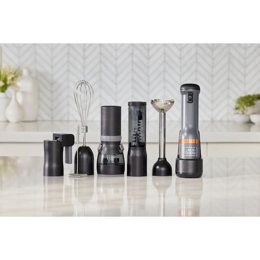 BLACKDECKER BCKM1016KSG hand blender set with multiple black and silver attachments displayed on a kitchen counter.