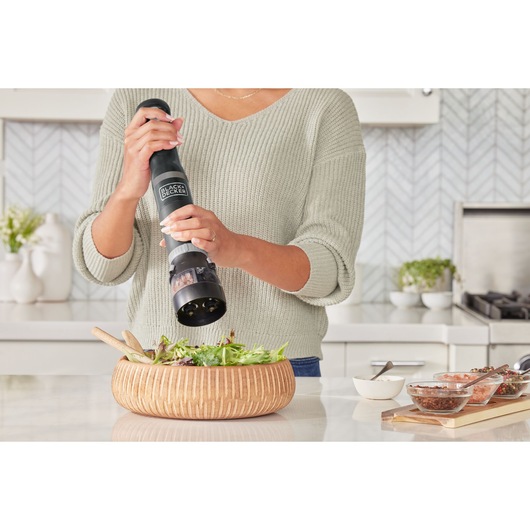 Photo of BLACKDECKER electric pepper mill BCKM101SPFF in use over a salad bowl in a modern kitchen.