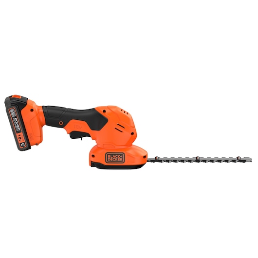 A BLACK+DECKER BCSS18D1 18V cordless handheld shrub and grass shear in orange and black, shown with a battery attached and a blade for trimming, placed on a white background.