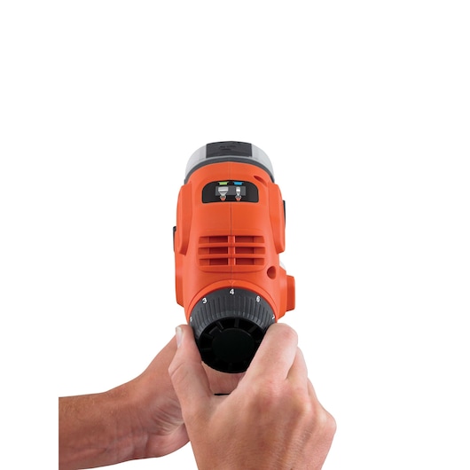 BLACKDECKER BDPS400 orange handheld tool front view with hands adjusting dial, photography category