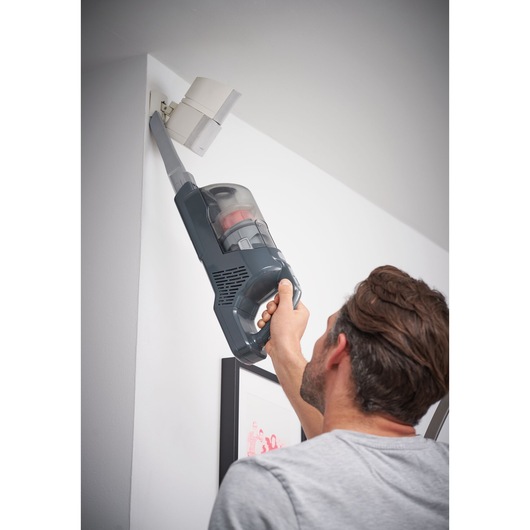 BLACKDECKER BHFEA520J handheld vacuum cleaner used to clean ceiling corner.