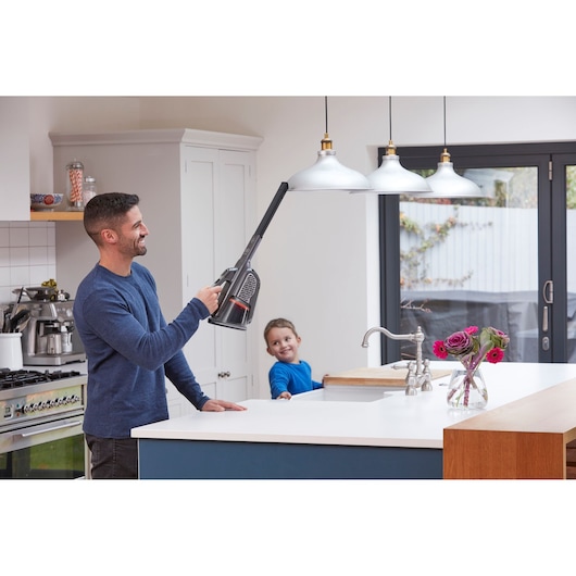 BLACKDECKER handheld vacuum BHHV520JF cleaning kitchen pendant lights with long nozzle attachment.