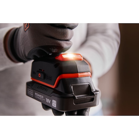BLACKDECKER BLD682XN 18V Lithium Power Connect battery shown in use close-up, with glove and LED indicator lit.