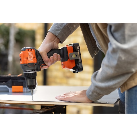 BLACKDECKER BLD782E1K cordless drill in use on wood, close-up view of tool and hand.