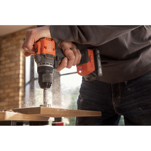Photo of BLACKDECKER cordless drill BLD782E1K in use drilling wood indoors.