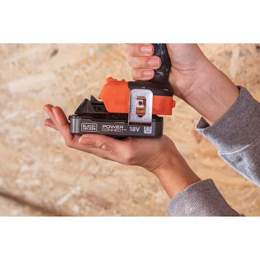 BLACK+DECKER BLD782E1K power tool with 18V 2.5Ah battery held in hands, close-up side view.