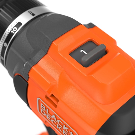 Close-up photo of BLACK+DECKER BLD782E1K orange cordless drill speed selector and branding, angled view.