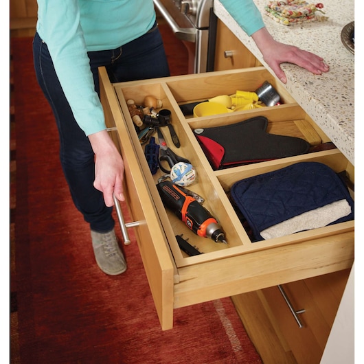 Photo of BLACKDECKER CS3653LC cordless screwdriver in a kitchen drawer with tools and kitchen items.