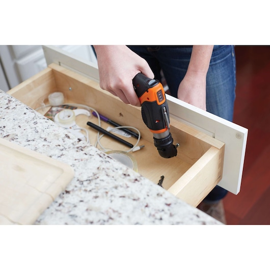 BLACKDECKER CSRA1 cordless screwdriver used to repair a kitchen drawer, close-up photography.