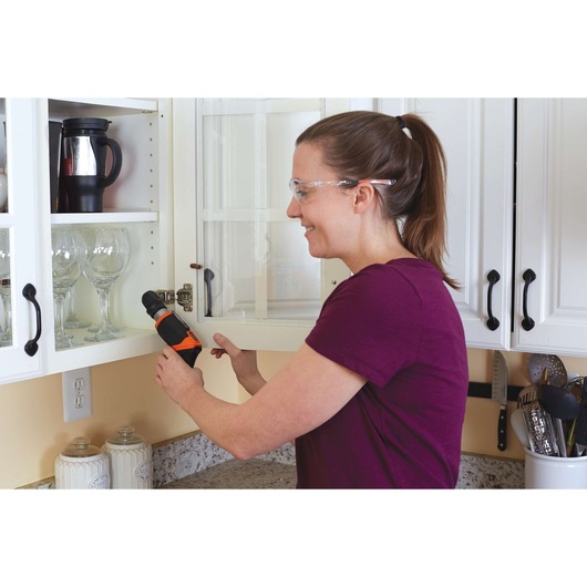 BLACKDECKER CSRA1 cordless screwdriver used to fix cabinet hinge in kitchen.