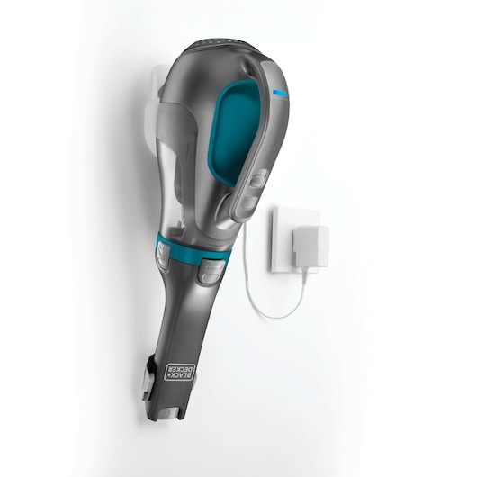 BLACKDECKER DV1015EL grey and teal handheld vacuum mounted on wall charging station, side angle.
