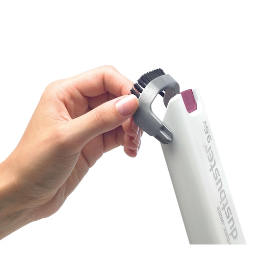 Photo of a hand attaching a brush accessory to BLACK+DECKER dustbuster 9.6V handheld vacuum DV9610ECN, white background.