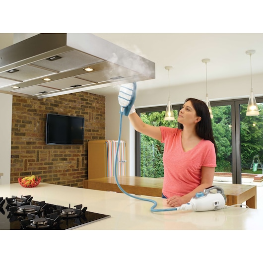 Photo of BLACKDECKER FSMH13101SM steam cleaner in use cleaning a kitchen vent hood.