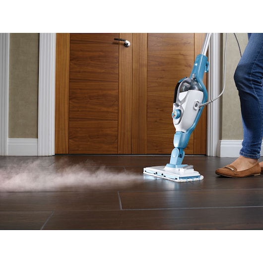 BLACKDECKER FSMH13101SM steam mop cleaning dark tile floor, side angle.