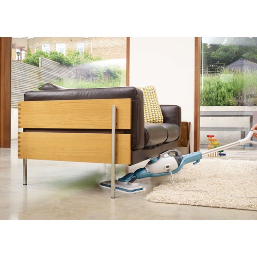 BLACKDECKER FSMH13151SM steam mop cleaning floor under sofa in living room, indoor angle.