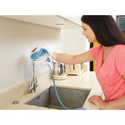 BLACKDECKER FSMH13151SM steam cleaner used on kitchen faucet and backsplash, photography, side angle