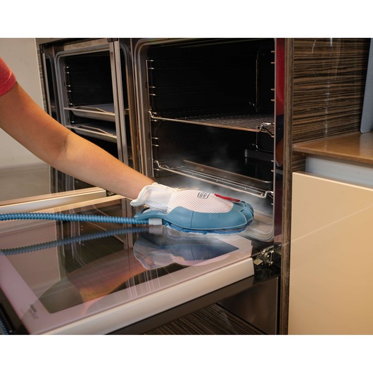 BLACKDECKER FSMH13151SM steam cleaning glove used on oven door surface.