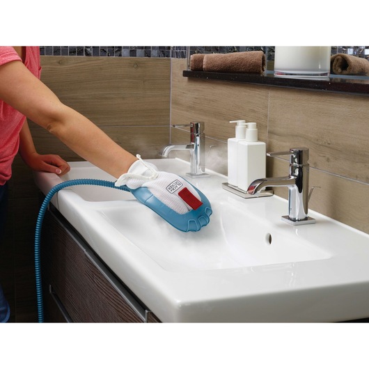 BLACKDECKER FSMH13151SM steam cleaning glove in use on a white bathroom sink.