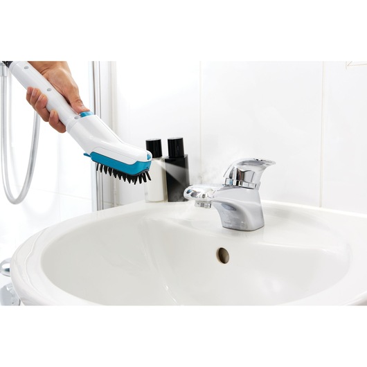 BLACKDECKER FSMH13151SM steam cleaner cleaning bathroom sink faucet with bristle brush attachment.