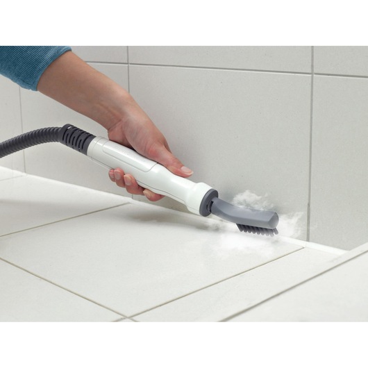 BLACKDECKER FSMH1321 steam cleaner handheld attachment cleaning tile grout, side angle.