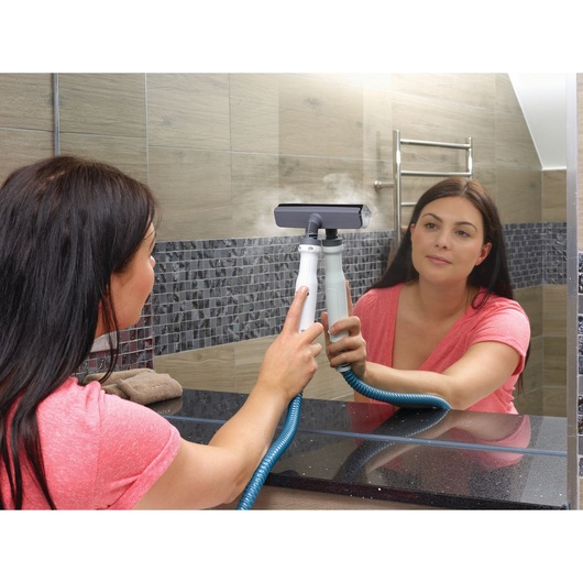 BLACKDECKER FSMH1351SM steam cleaner used to clean bathroom mirror, person holding the device.