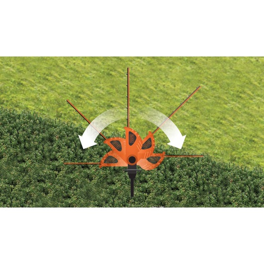 BLACKDECKER GTC1843L hedge trimmer demonstrating adjustable cutting head positions on green hedge, top view.