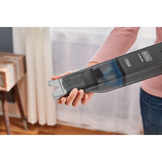 BLACK+DECKER HLVC320J11 cordless handheld vacuum cleaner held in hand, close-up angle.