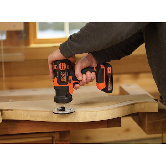 BLACKDECKER MT218K cordless power tool used on wood in workshop, orange-black design.