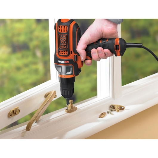 BLACKDECKER MT350k multi-tool drill used for window hardware installation, close-up view.