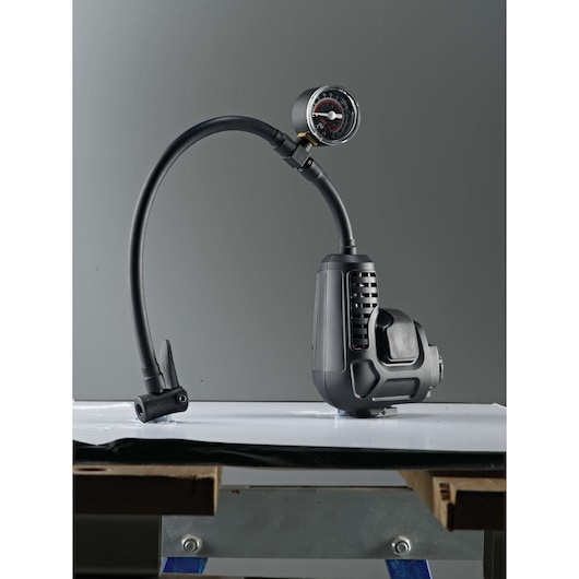 BLACKDECKER MTNF9 tire inflator MT218K_E1 with gauge, black, side angle, on white surface.