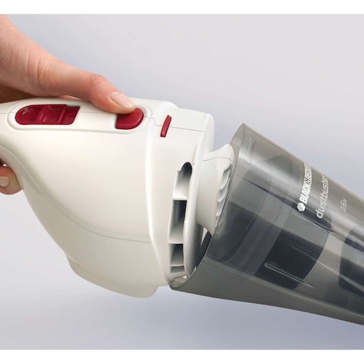 Close-up photo of BLACK+DECKER NV3610N handheld vacuum cleaner with dust container being removed.