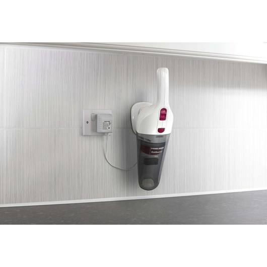 BLACKDECKER NV3610N handheld vacuum in white and black, wall-mounted and charging, side angle.