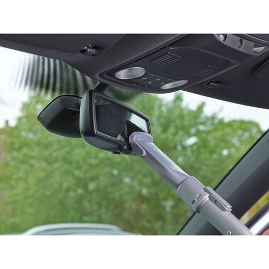 BLACKDECKER PD1200AV vacuum nozzle cleaning car rearview mirror, close-up angle.