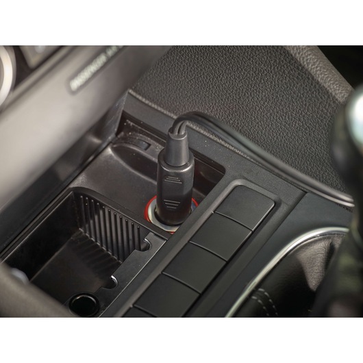 BLACKDECKER PV1200AV car charger plug inserted into vehicle outlet, close-up angle.