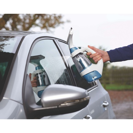 BLACKDECKER WW100 window vacuum cleaner used on car window, handheld, blue and white design.